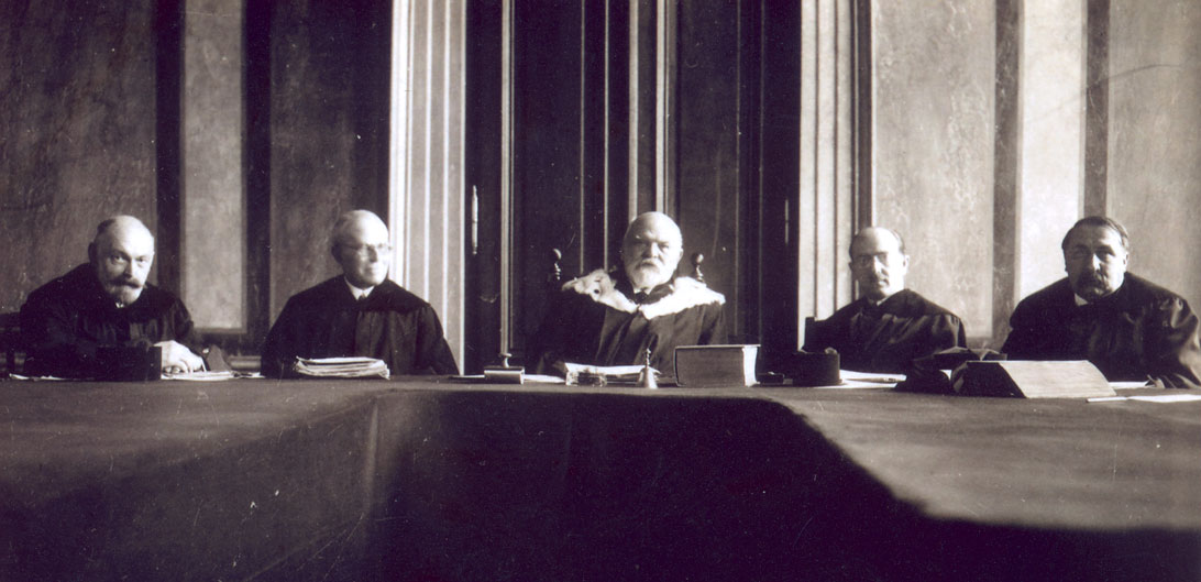 A senate of the Constitutional Court, 2nd half of the 1920s (In the middle: President Paul Vittorelli; second from the right: Hans Kelsen; second from the left: Friedrich Engel) [Provided by and used with permission of Anne Feder Lee, Ph.D.m granddaughter of Hans Kelsen]